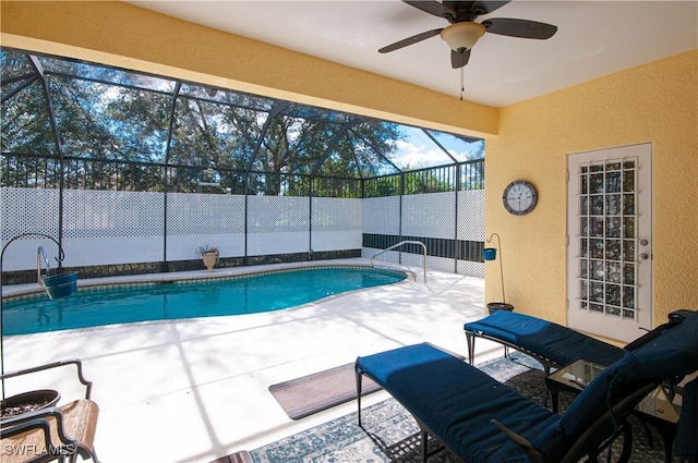 view of swimming pool featuring a lanai, a patio, and ceiling fan