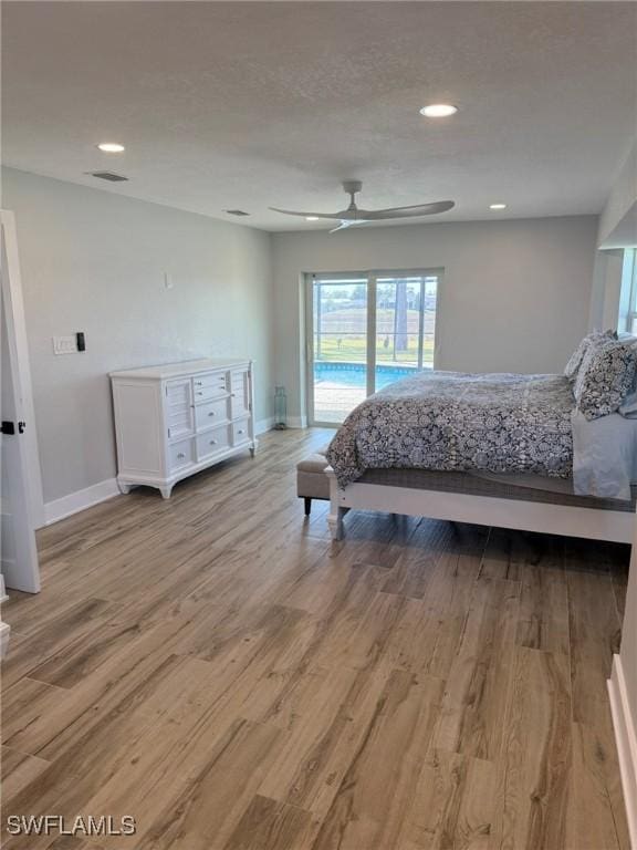 bedroom featuring access to exterior, hardwood / wood-style floors, and ceiling fan