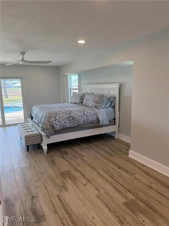 bedroom with wood-type flooring, access to exterior, and ceiling fan