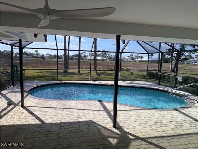 view of pool with ceiling fan, a lanai, and a patio area