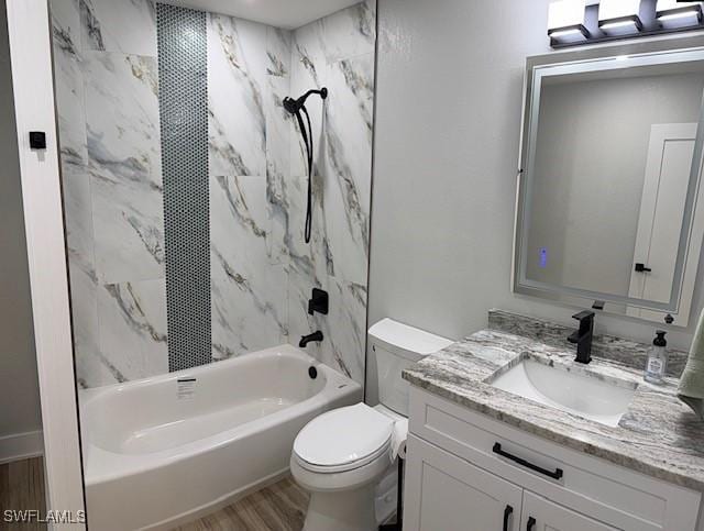 bathroom featuring vanity, tub / shower combination, wood finished floors, and toilet