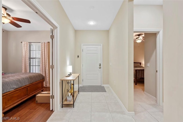 entrance foyer with light tile patterned flooring and ceiling fan