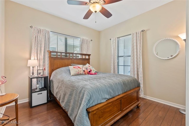 bedroom with multiple windows, ceiling fan, and dark hardwood / wood-style flooring