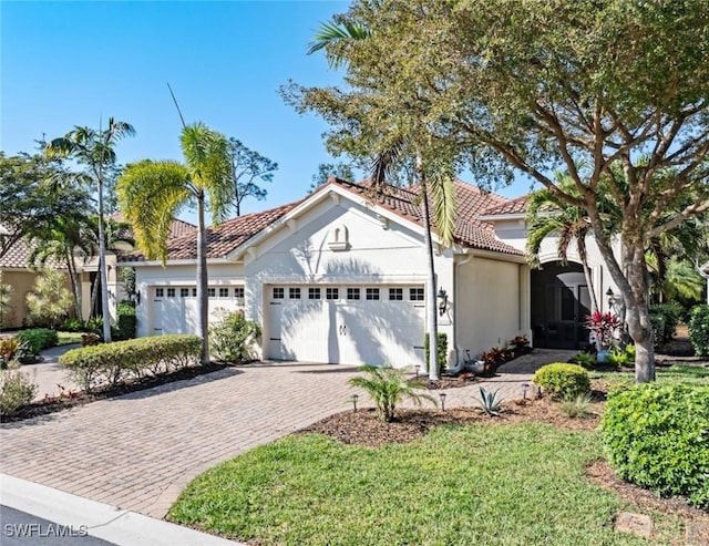 mediterranean / spanish-style house with a garage