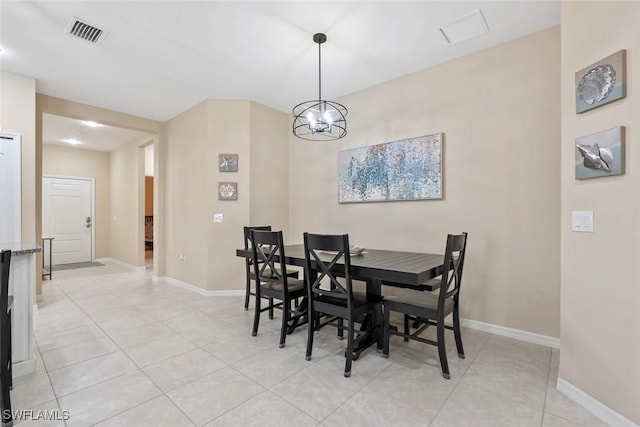 dining area with light tile patterned flooring and a chandelier