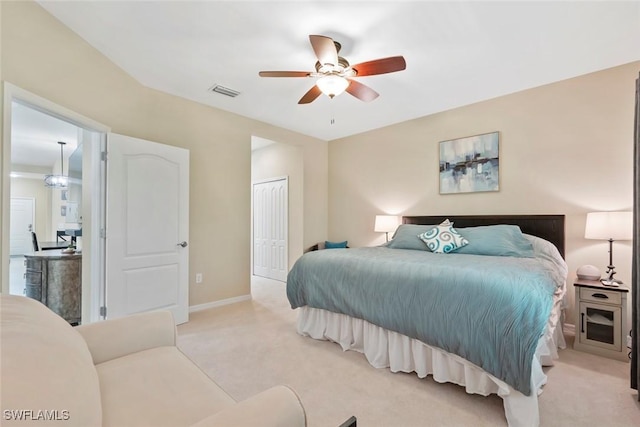 bedroom featuring a closet, ceiling fan, and light colored carpet