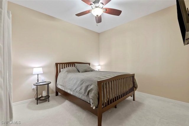 bedroom with light carpet and ceiling fan