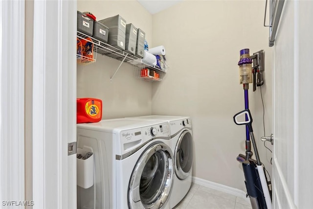 washroom featuring washer and dryer and light tile patterned floors