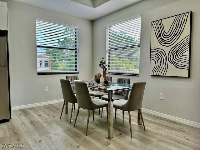 dining space with light wood-type flooring