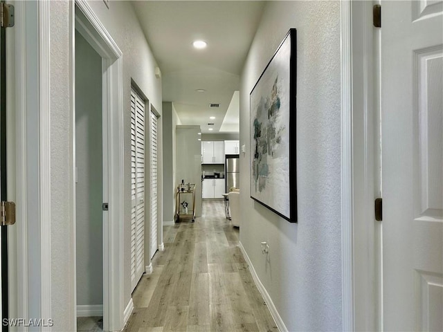 corridor featuring light hardwood / wood-style floors