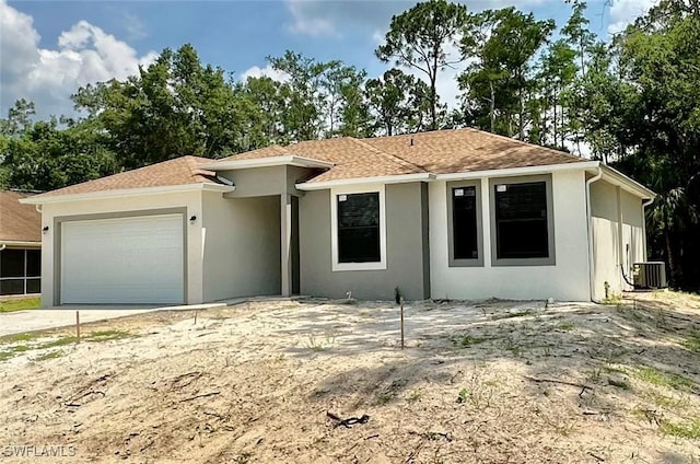 view of front of property featuring a garage and central air condition unit