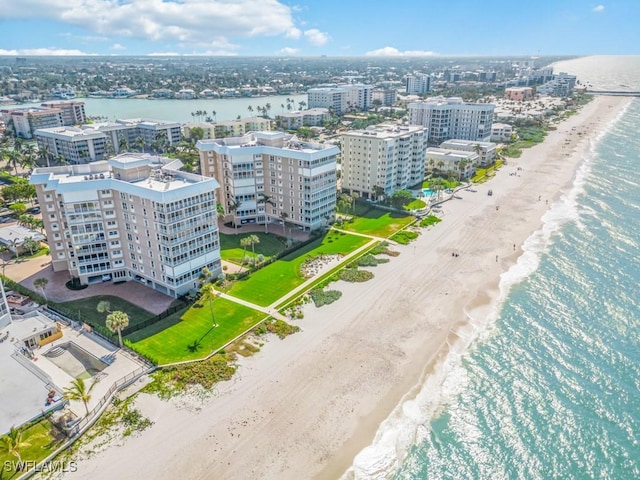 drone / aerial view featuring a view of the beach and a water view