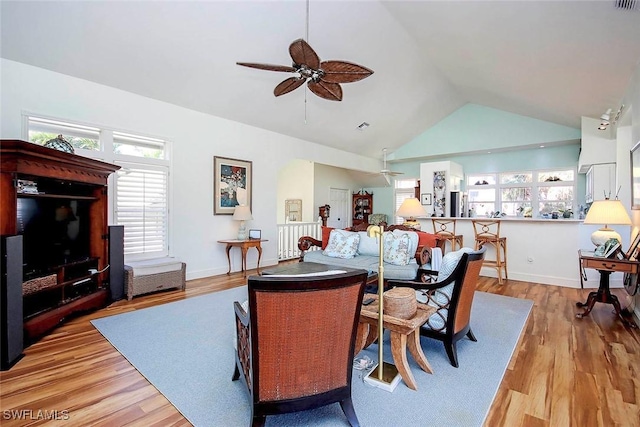 dining space featuring ceiling fan, high vaulted ceiling, and light hardwood / wood-style floors