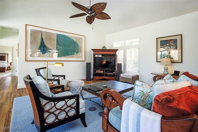 living room with ceiling fan, lofted ceiling, and wood-type flooring