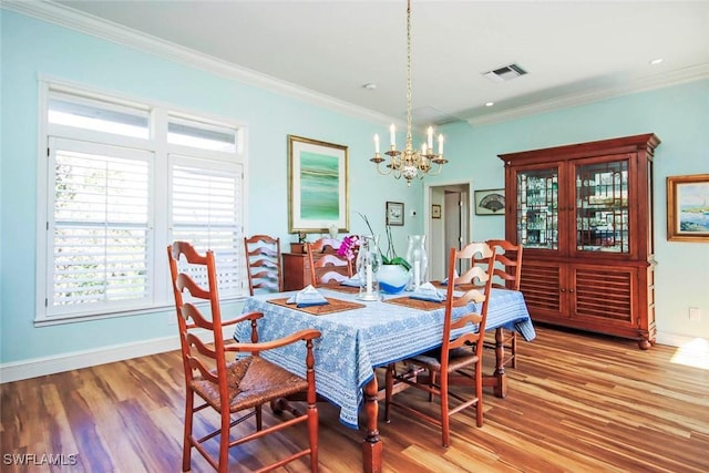 dining area featuring crown molding and wood-type flooring