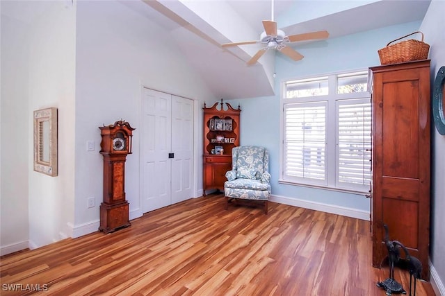 unfurnished room featuring lofted ceiling, ceiling fan, and light hardwood / wood-style flooring