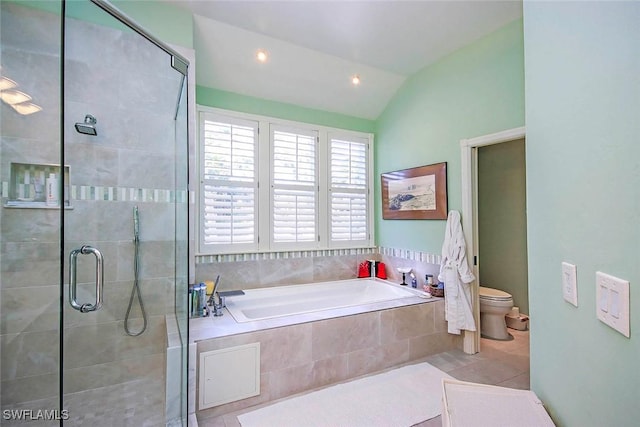 bathroom featuring toilet, lofted ceiling, shower with separate bathtub, and tile patterned flooring