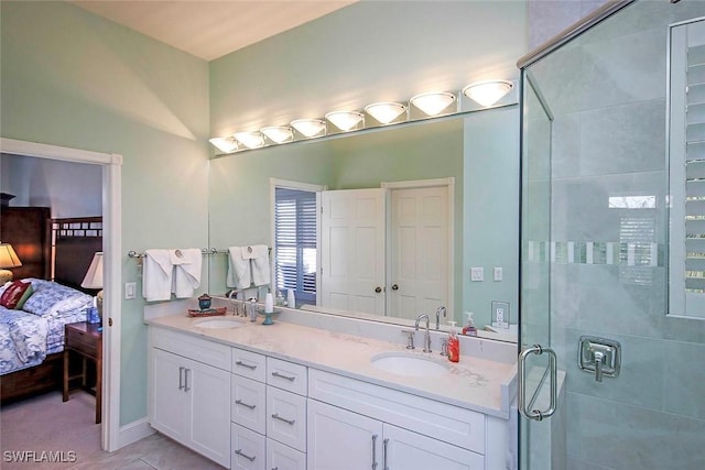 bathroom with vanity, an enclosed shower, and tile patterned flooring