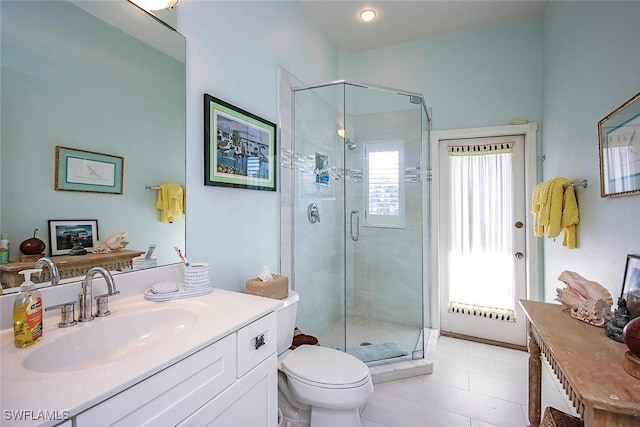 bathroom featuring vanity, an enclosed shower, and toilet