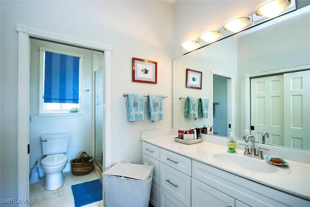 bathroom featuring walk in shower, tile patterned floors, vanity, and toilet