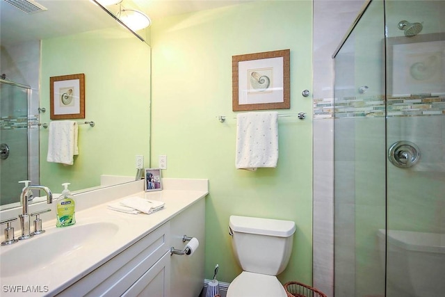 bathroom featuring walk in shower, vanity, and toilet