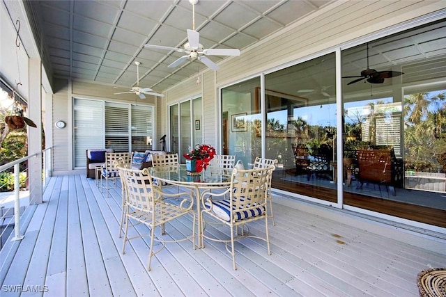 wooden deck featuring ceiling fan