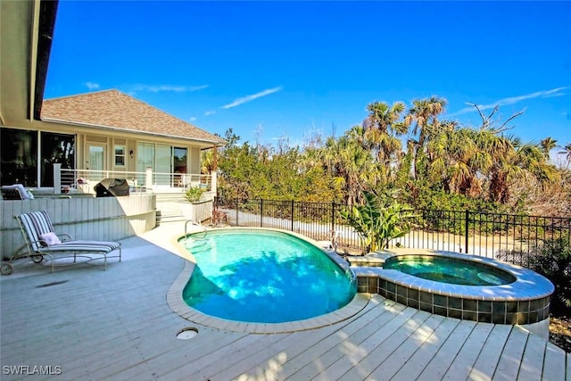 view of swimming pool featuring a patio and an in ground hot tub