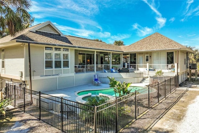 back of house with a fenced in pool and a patio area