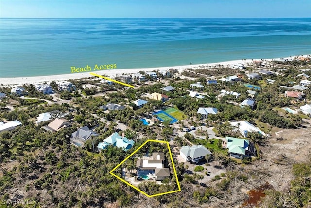 aerial view with a water view and a beach view