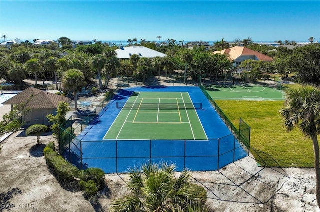 view of sport court with basketball court and a lawn