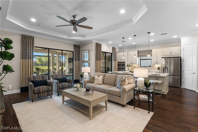 living room featuring crown molding, ceiling fan, a raised ceiling, and light hardwood / wood-style floors