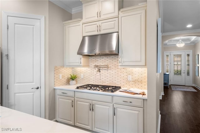 kitchen featuring white cabinetry, ornamental molding, and stainless steel gas cooktop