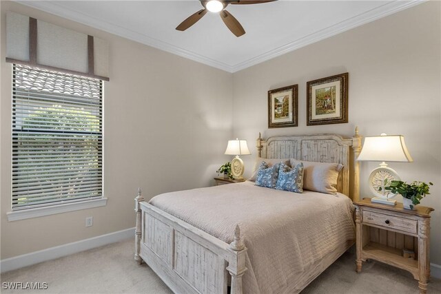 bedroom with crown molding, ceiling fan, and light carpet