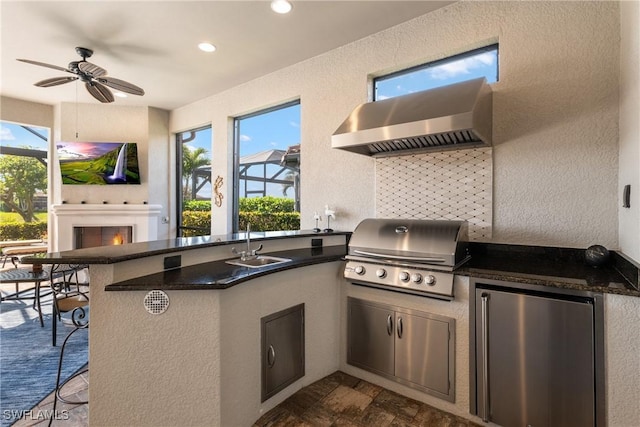 view of patio / terrace featuring an outdoor kitchen, area for grilling, sink, and ceiling fan