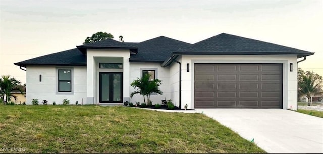 view of front of property featuring a garage and a front yard