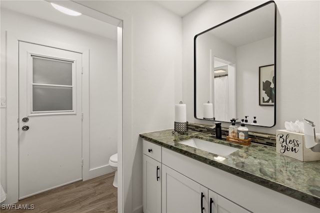 bathroom with vanity, wood-type flooring, and toilet