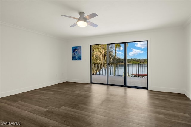 spare room with a water view, ceiling fan, ornamental molding, and dark hardwood / wood-style flooring