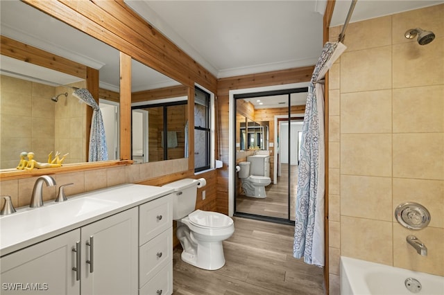 full bathroom with toilet, wood-type flooring, shower / tub combo, ornamental molding, and vanity