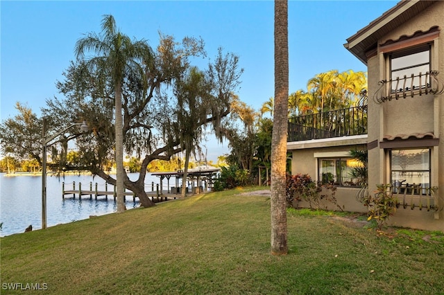 view of yard featuring a boat dock and a water view