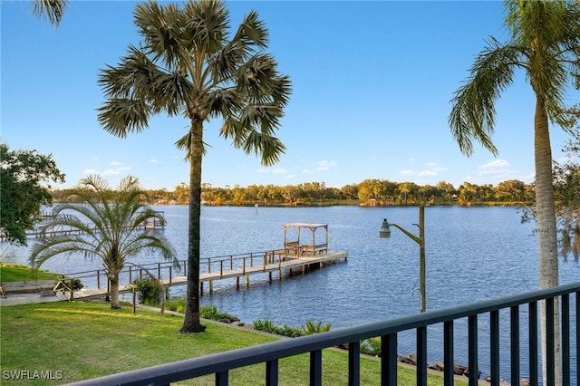 dock area featuring a water view and a lawn