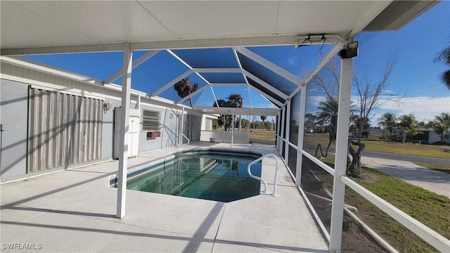 view of pool featuring a patio and glass enclosure