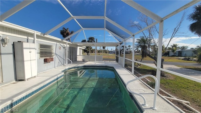 view of swimming pool with a lanai and a patio