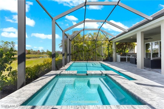 view of swimming pool featuring a patio, a lanai, and ceiling fan