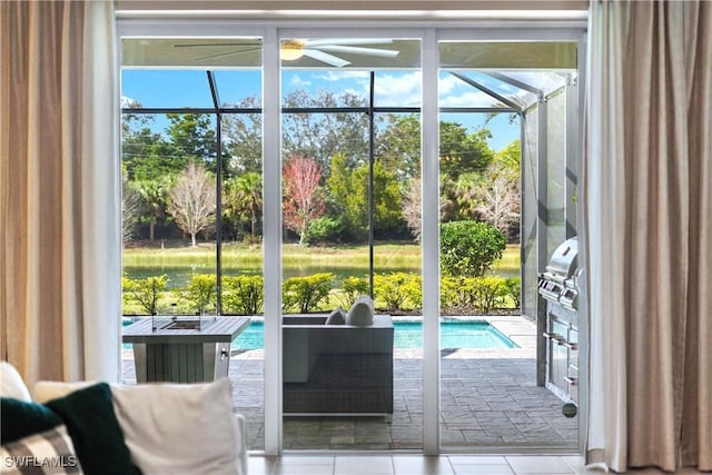 doorway to outside with light tile patterned flooring and ceiling fan