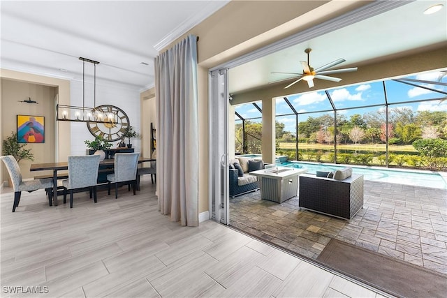 view of patio featuring ceiling fan, an outdoor living space, and glass enclosure