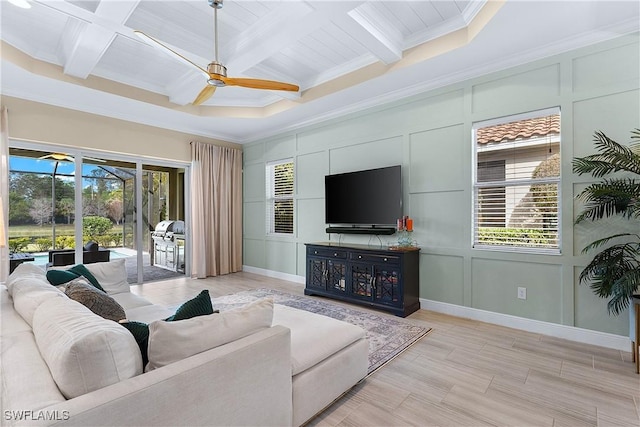 living room featuring coffered ceiling, beam ceiling, crown molding, and ceiling fan