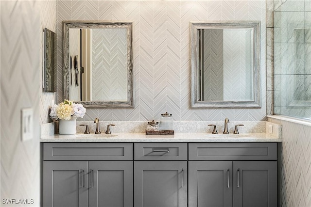 bathroom with vanity and tile walls