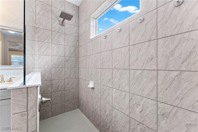 bathroom with vanity and tiled shower