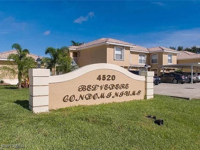 community / neighborhood sign featuring a yard