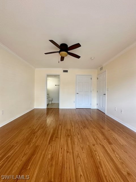 unfurnished bedroom with crown molding, hardwood / wood-style floors, and ceiling fan